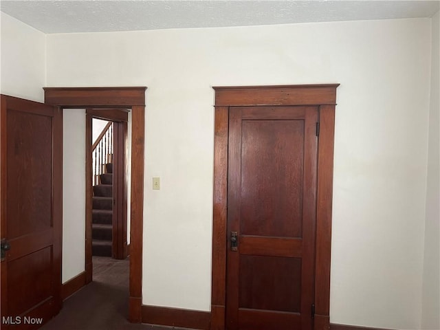 324 Elm St, Struthers, OH 44471 - hall featuring dark colored carpet, baseboards, and stairs