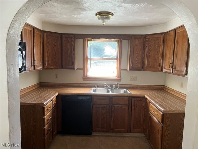 324 Elm St, Struthers, OH 44471 - kitchen with a sink, light countertops, black appliances, and brown cabinets