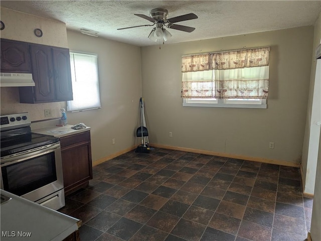10648 State Route 37 E, New Lexington, OH 43764 - kitchen featuring a ceiling fan, a textured ceiling, under cabinet range hood, baseboards, and stainless steel range with electric cooktop