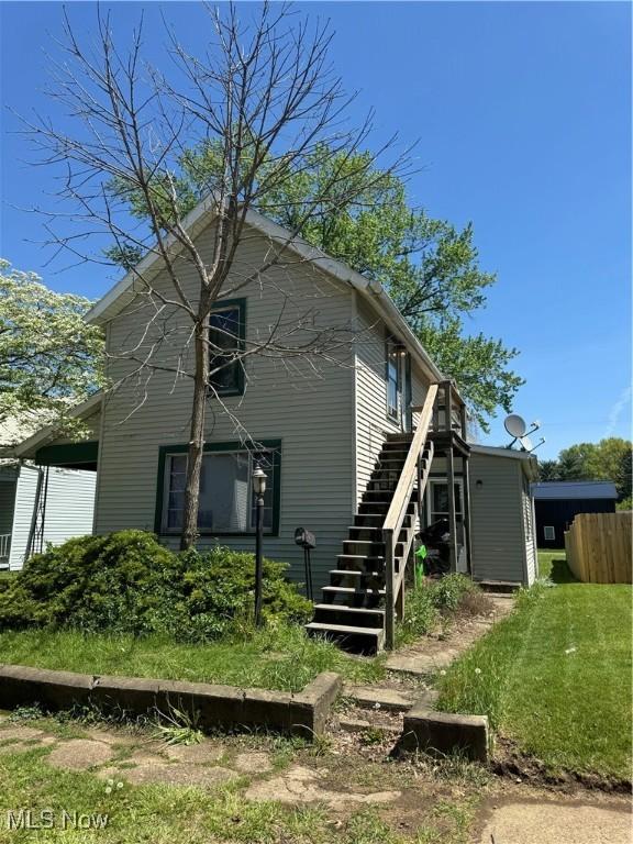 rear view of house featuring stairs