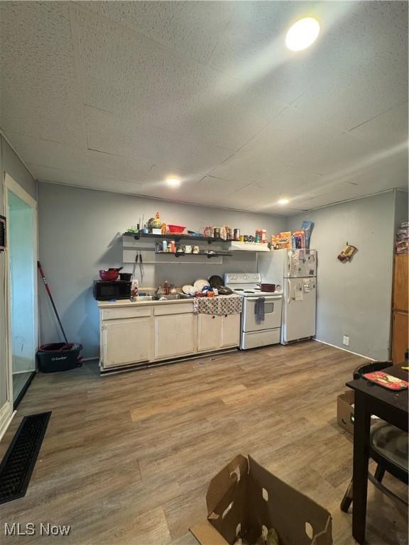 722 John St, Coshocton, OH 43812 - kitchen featuring white appliances and light wood finished floors
