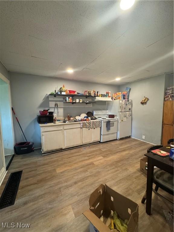 722 John St, Coshocton, OH 43812 - kitchen with white appliances and light wood-style flooring