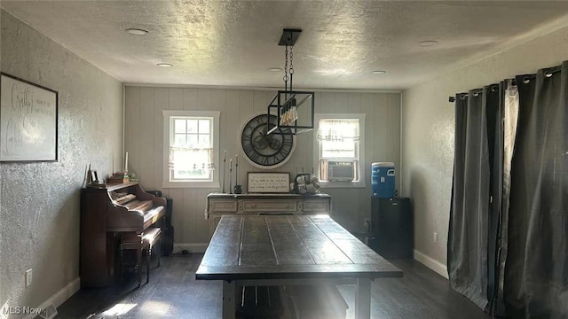 2320 Leetonia Rd, Leetonia, OH 44431 - dining room featuring a textured wall, wood finished floors, a textured ceiling, baseboards, and cooling unit