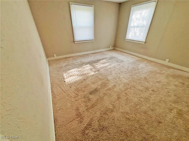 spare room with carpet flooring and baseboards