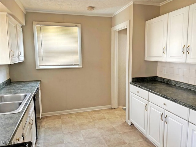 kitchen featuring dark countertops, white cabinetry, ornamental molding, and backsplash
