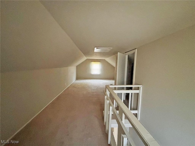 bonus room with carpet flooring and lofted ceiling