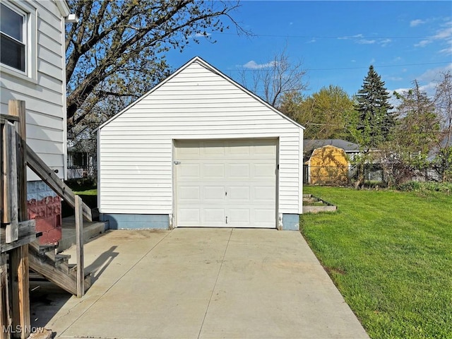 detached garage featuring driveway