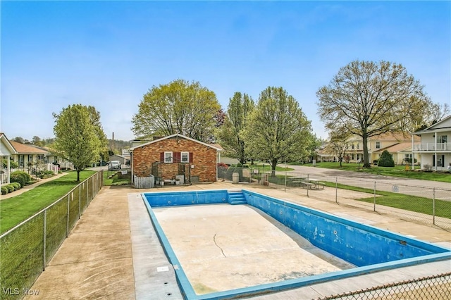 view of swimming pool featuring fence, a fenced in pool, and a residential view