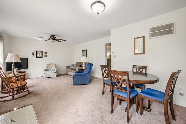 dining room featuring ceiling fan, light carpet, and visible vents