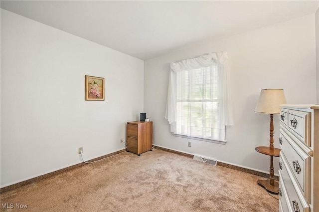 bedroom with baseboards, visible vents, and carpet