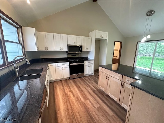 5869 Amy Boyle Rd NE, Brookfield, OH 44403 - kitchen with light wood-style flooring, a sink, high vaulted ceiling, white cabinets, and appliances with stainless steel finishes
