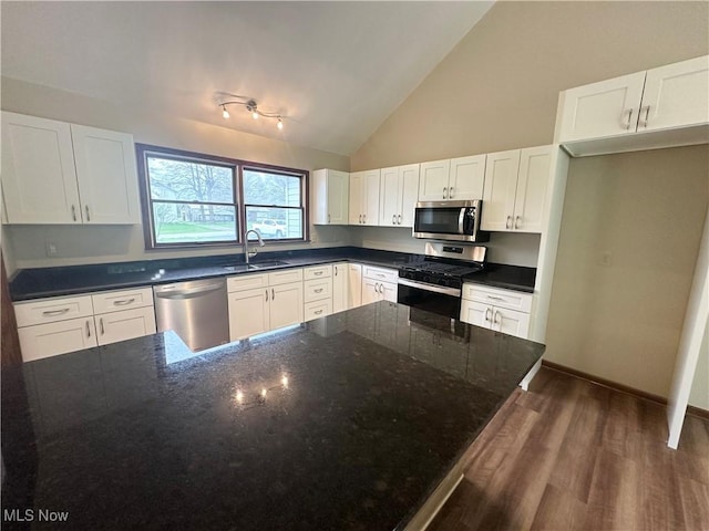 5869 Amy Boyle Rd NE, Brookfield, OH 44403 - kitchen with wood finished floors, a sink, dark stone counters, stainless steel appliances, and white cabinetry