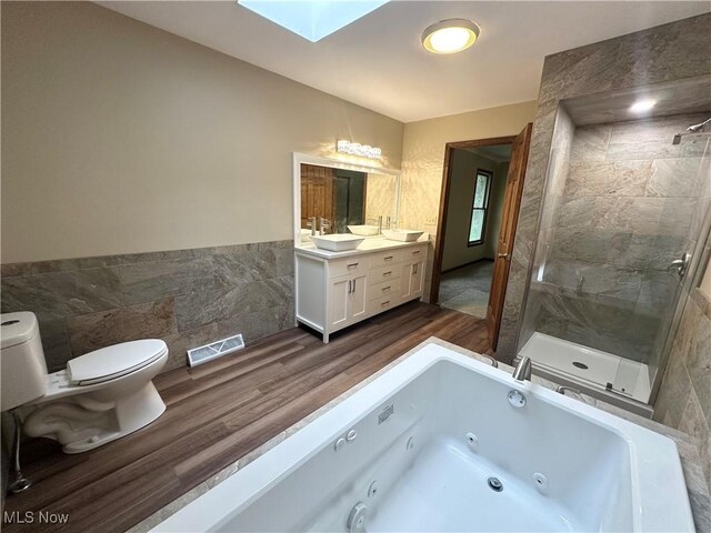 5869 Amy Boyle Rd NE, Brookfield, OH 44403 - bathroom with a shower stall, tile walls, visible vents, and a skylight