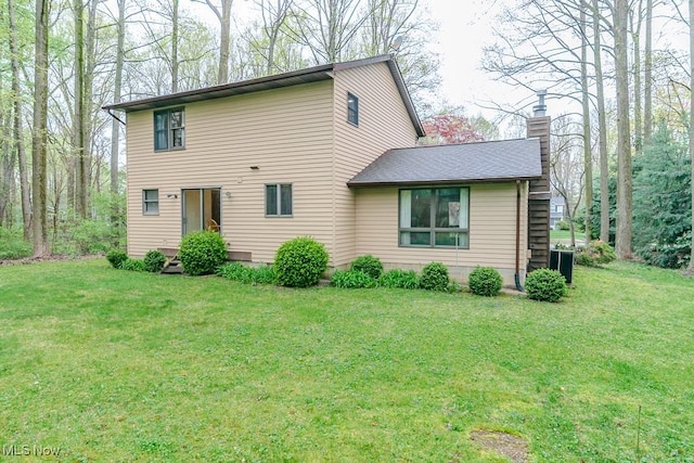 9122 Katherine Ct, Mentor, OH 44060 - view of front of home with a front lawn, a chimney, and central air condition unit