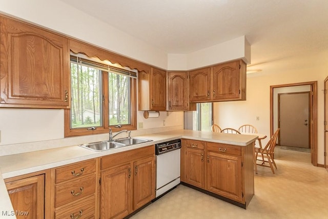 9122 Katherine Ct, Mentor, OH 44060 - kitchen with brown cabinetry, white dishwasher, a peninsula, and a sink