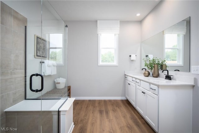 3991 Crestview Dr, Green, OH 44685 - bathroom with a sink, double vanity, a shower with door, and wood finished floors