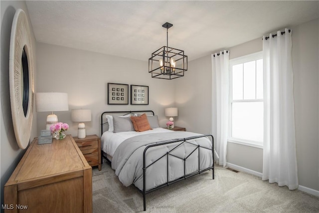 3991 Crestview Dr, Green, OH 44685 - bedroom featuring baseboards, an inviting chandelier, visible vents, and light colored carpet