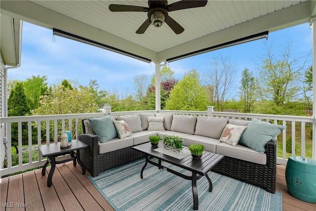 wooden terrace featuring an outdoor living space and a ceiling fan
