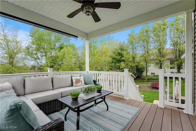 wooden terrace with ceiling fan and an outdoor hangout area