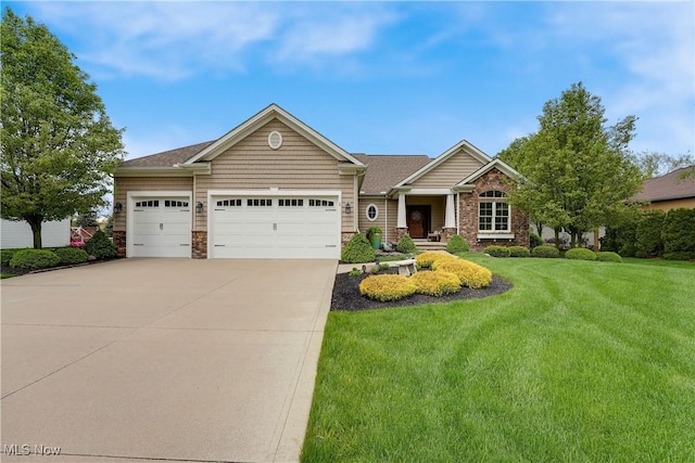 view of front facade featuring concrete driveway, an attached garage, stone siding, and a front yard