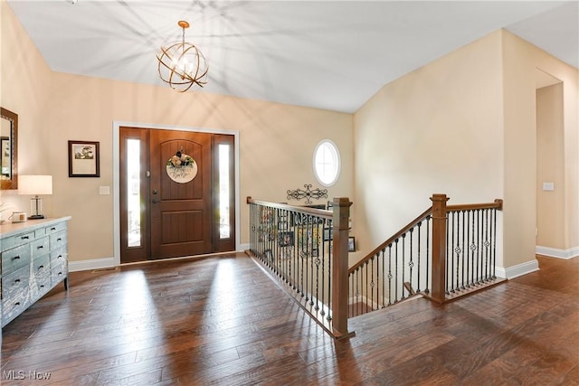 entrance foyer featuring wood finished floors, baseboards, and a notable chandelier