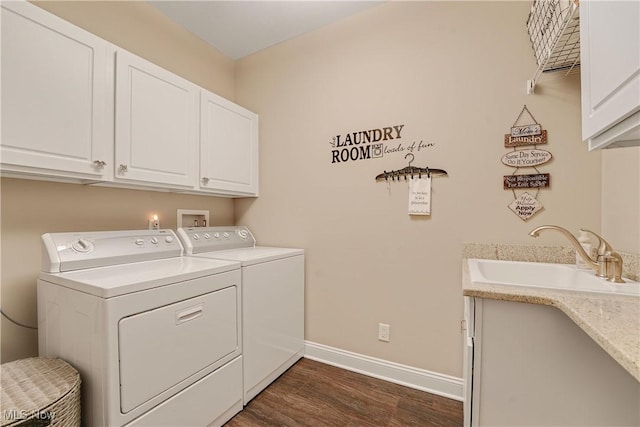 clothes washing area featuring a sink, cabinet space, separate washer and dryer, dark wood-style flooring, and baseboards