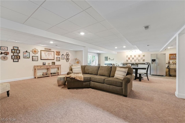 living area featuring light carpet, baseboards, visible vents, and recessed lighting