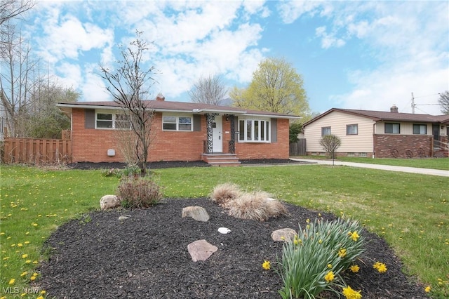 6544 Nancy Dr, North Olmsted, OH 44070 - view of front facade featuring brick siding, fence, and a front yard