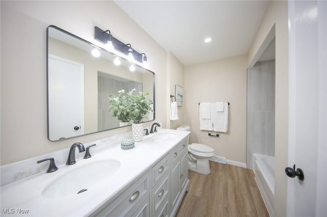 6544 Nancy Dr, North Olmsted, OH 44070 - bathroom with a sink, double vanity, toilet, and wood finished floors