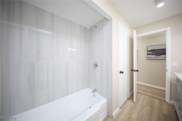 6544 Nancy Dr, North Olmsted, OH 44070 - full bathroom featuring wood finished floors, shower / washtub combination, visible vents, baseboards, and vanity