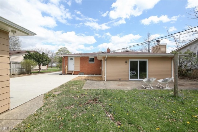 6544 Nancy Dr, North Olmsted, OH 44070 - rear view of house featuring brick siding, a yard, a patio, entry steps, and a chimney