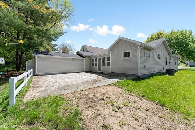 view of front of property featuring a front lawn, a patio, central AC unit, and fence