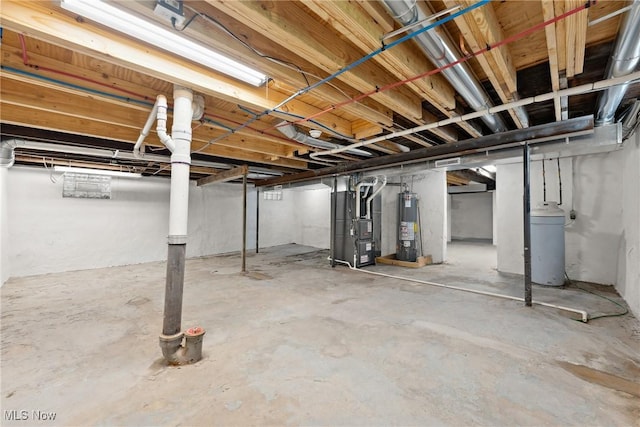 unfinished below grade area featuring heating unit and water heater