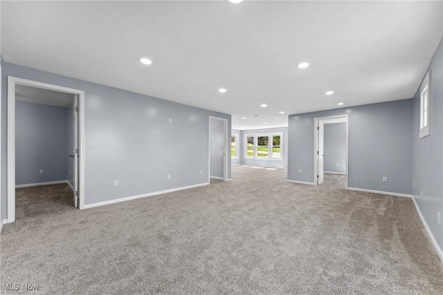 carpeted empty room with baseboards and recessed lighting