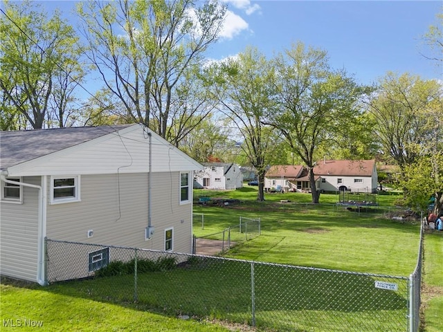 view of property exterior with a yard and fence