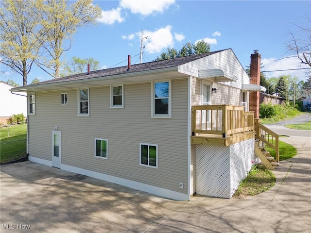back of property featuring a chimney