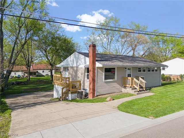 bungalow featuring driveway, a chimney, and a front yard