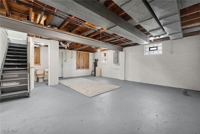 basement featuring electric panel and stairway