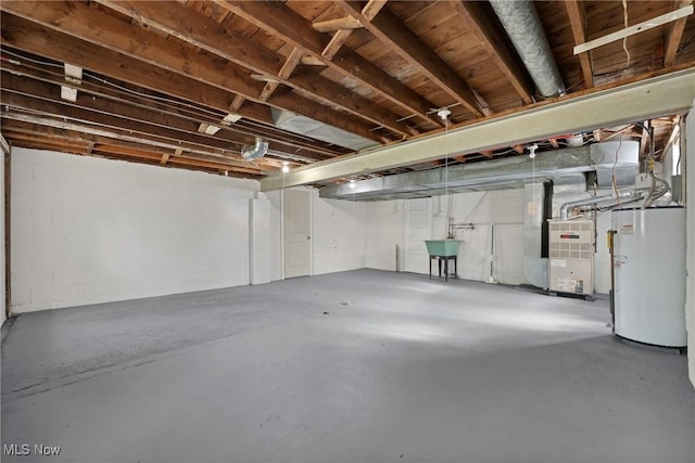 unfinished basement featuring heating unit, water heater, and a sink