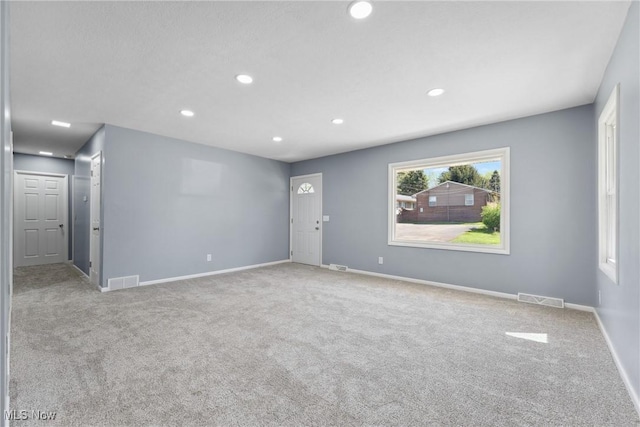 spare room with baseboards, recessed lighting, visible vents, and carpet floors