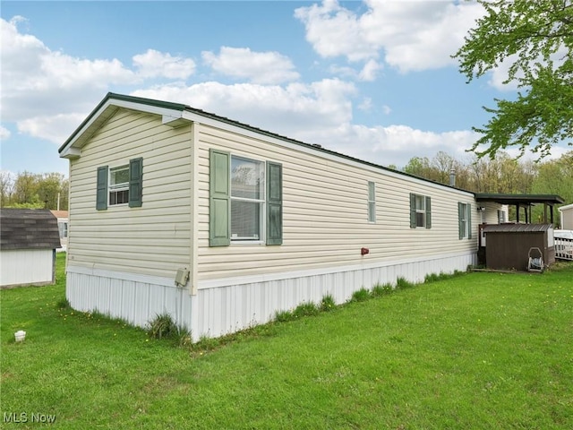 184 Garfield Ln, Jefferson, OH 44047 - view of side of home featuring a yard, an outbuilding, and a storage unit
