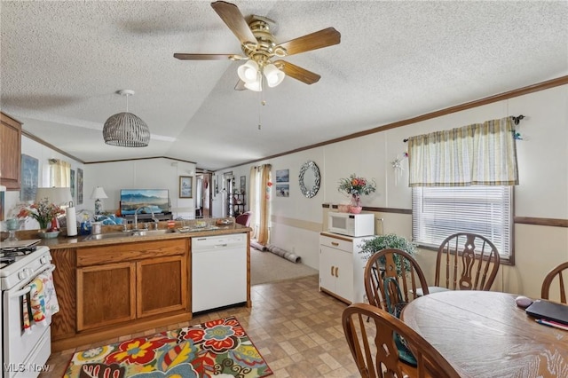 184 Garfield Ln, Jefferson, OH 44047 - kitchen featuring brown cabinetry, white appliances, a peninsula, and crown molding