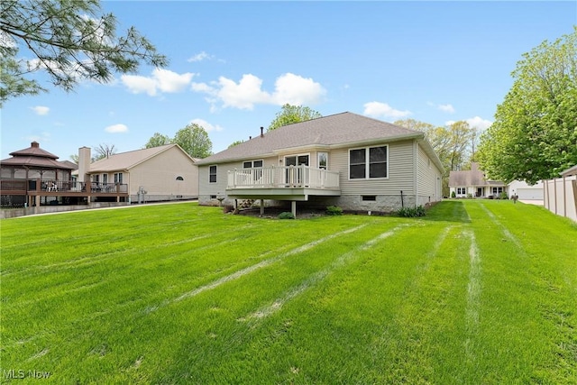 back of property featuring fence and a lawn