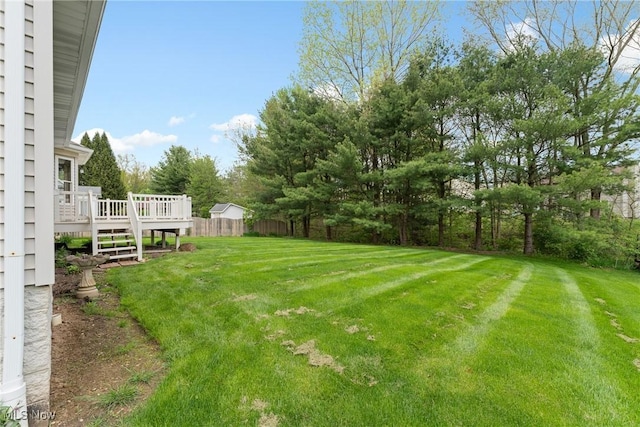 view of yard with fence and a wooden deck