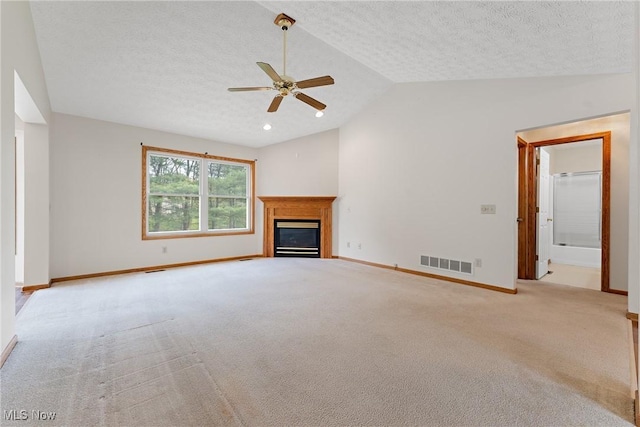 unfurnished living room with lofted ceiling, baseboards, carpet flooring, ceiling fan, and visible vents