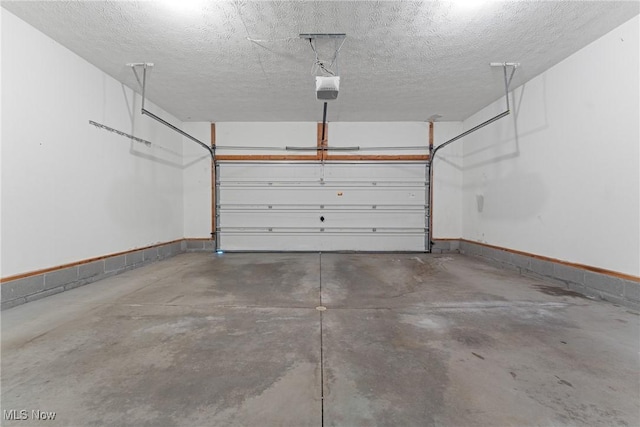 garage with baseboards and a garage door opener