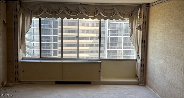 spare room with light colored carpet and a healthy amount of sunlight
