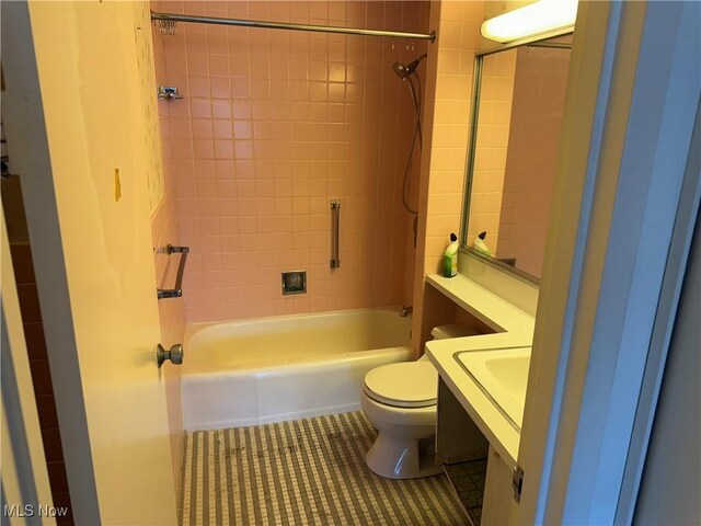 bathroom featuring toilet, tile patterned floors, vanity, and bathtub / shower combination
