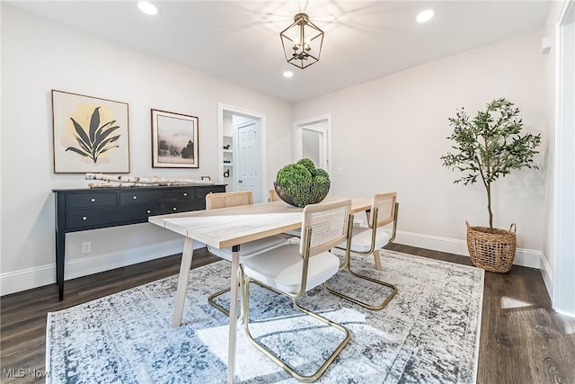 dining room with baseboards, a notable chandelier, recessed lighting, and dark wood-type flooring
