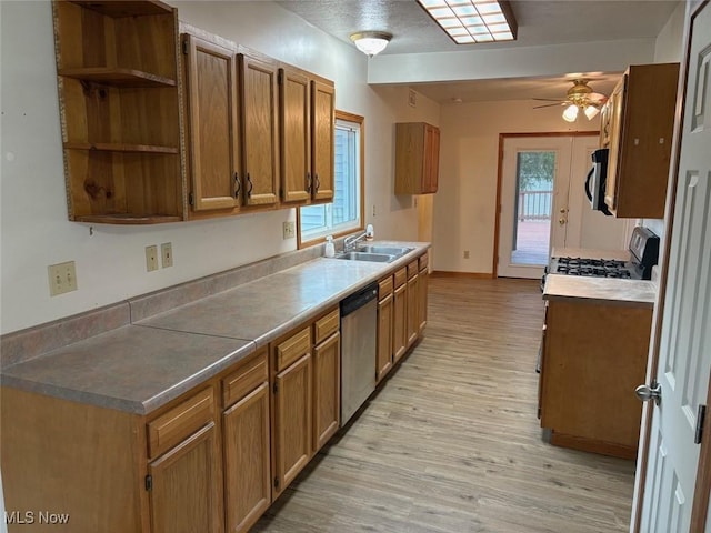 kitchen with a ceiling fan, dishwasher, light wood finished floors, a sink, and brown cabinets
